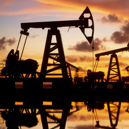 an oil field at sunset