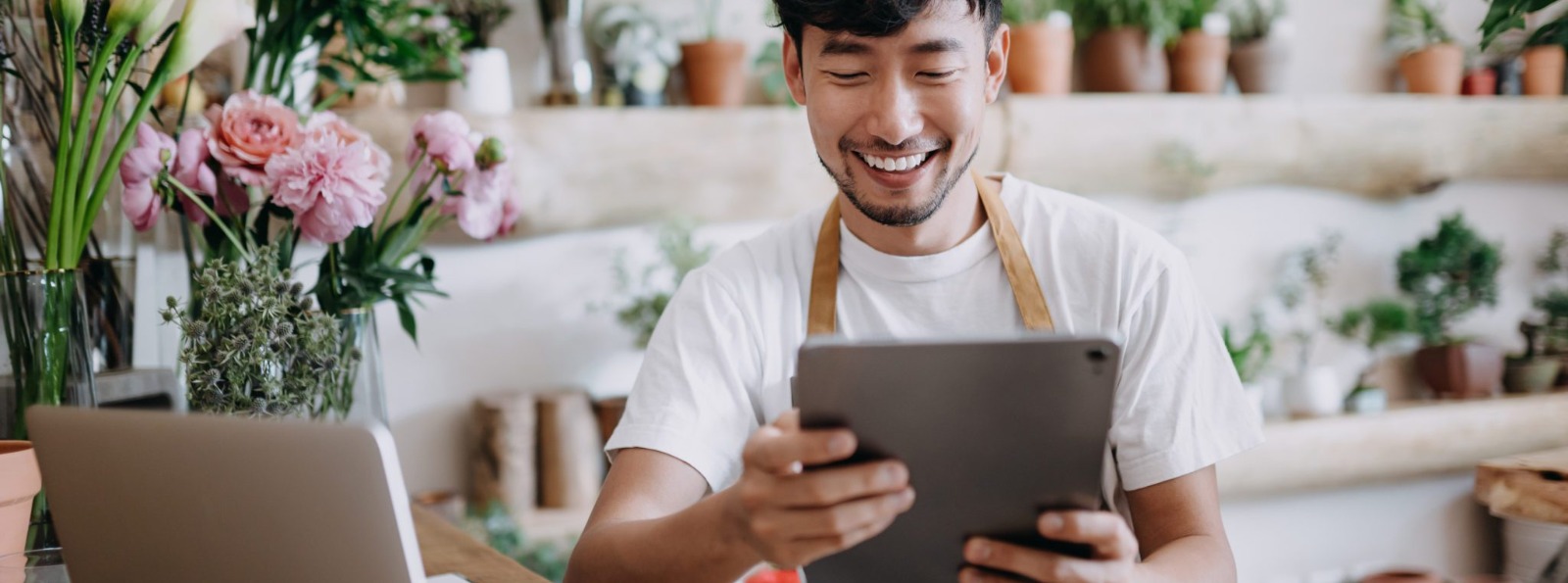 a small business owner looking at his tablet